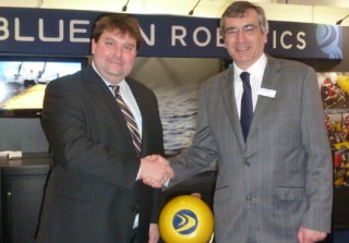 Omer Poroy (Bluefin Robotics) and Nick Swift (Sonardyne) on stand with Bluefin Robotics' AUV at Oceanology International.