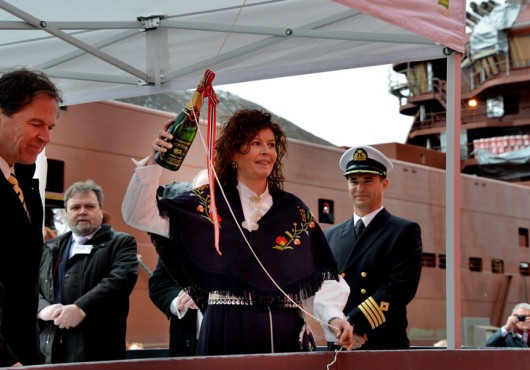 The vessel’s Lady Sponsor preparing to smash the champagne on the hull.