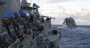 A group of Royal Australian Navy sailors aboard the Royal Australian Navy frigate HMAS Perth awaits Military Sealift Command dry cargo and ammunition ship USNS Cesar Chavez, right, at the start of a replenishment-at-sea in the Indian Ocean, April 12, 2014. The Perth is participating in the search for missing Malaysia Airlines Flight MH370. Royal Australian Navy photo by Able Seaman Imagery Specialist Nicolas Gonzalez