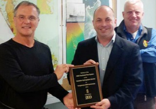 Kongsberg Maritime Subsea Sales Manger in Canada, Nick Burchill presented a plaque to Denis D'Amours
