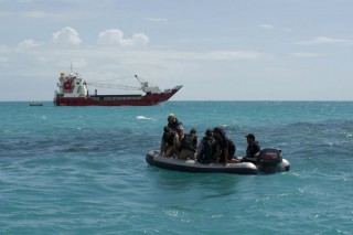 Clearance Divers from the Royal Australian Navy's Clearance Diving Team 1 and members of the Republic of Kiribati Maritime Police head out to the site of a suspect object.